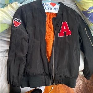 Black varsity jacket.